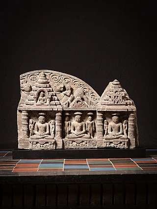 Antique Indian Jain stone panel with three seated figures in niches, full front view