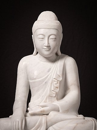 Marble Buddha statue close-up of face and torso, front view