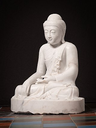 Marble Buddha statue from Myanmar in bhumisparsha mudra, three-quarter view
