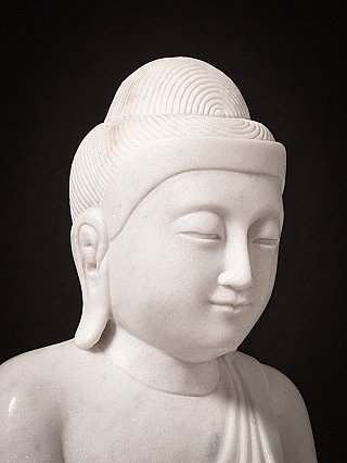Face detail of the Burmese marble Buddha, showing serene features and hair