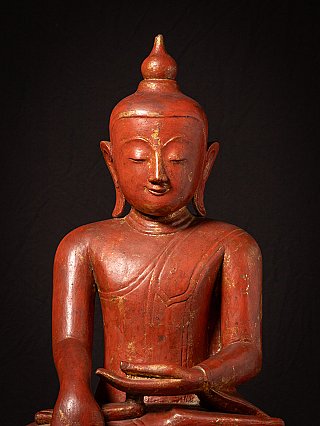 Face and chest detail of the wooden Ava Buddha statue, with traces of gilding