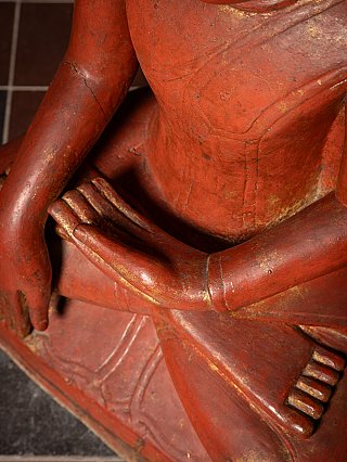 Hands and knees detail showing the bhumisparsha mudra on the seated Buddha