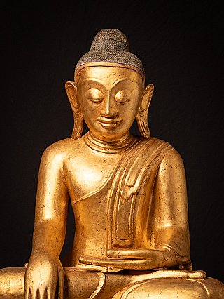 Close-up of the face and chest of the Myanmar lacquerware Buddha statue