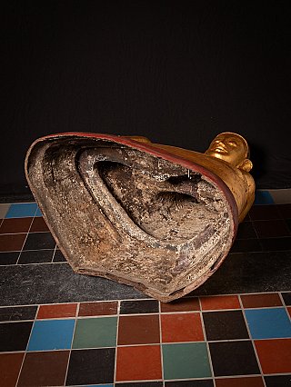 Underside of the large Burmese lacquerware Buddha statue, shown lying with hollow base