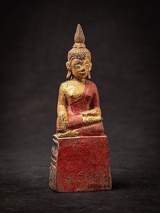 Thai wooden Buddha statue with red lacquer and gilding, slight angled front view