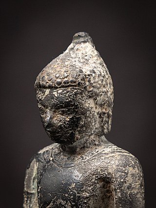 Three-quarter head detail of the Burmese bronze Buddha statue showing textured hair
