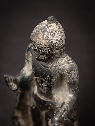 Crown and hair detail of the Burmese bronze Buddha statue photographed from above