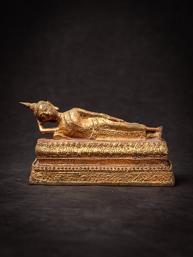 Old bronze reclining Thai Buddha