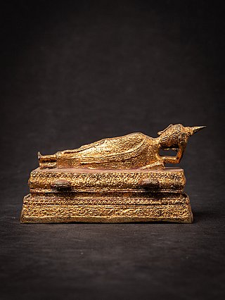 Old bronze reclining Thai Buddha