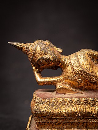 Old bronze reclining Thai Buddha