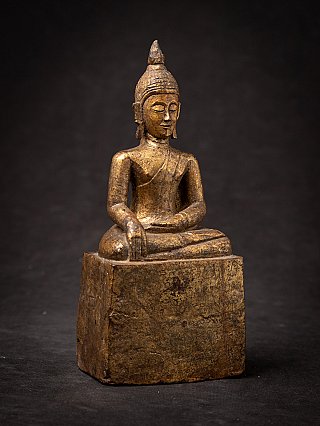 Antique Thai wooden Buddha statue in bhumisparsha mudra, three-quarter front view