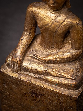 Hands and legs detail of the Thai wooden Buddha statue in bhumisparsha mudra