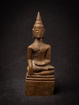 Thai wooden Buddha statue in bhumisparsha mudra, full front with worn surface