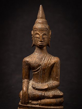 Close view of the Thai wooden Buddha statue showing hands and torso