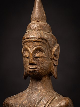 Close-up face of the Thai wooden Buddha statue showing surface cracking