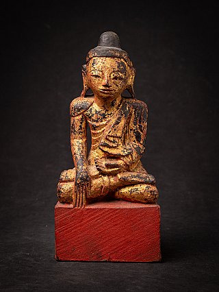 Burmese wooden Buddha statue in bhumisparsha mudra, full front on red base