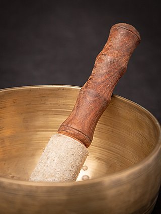 Houten klopper met omwikkelde punt in de bronzen zingkom uit Nepal, detailopname