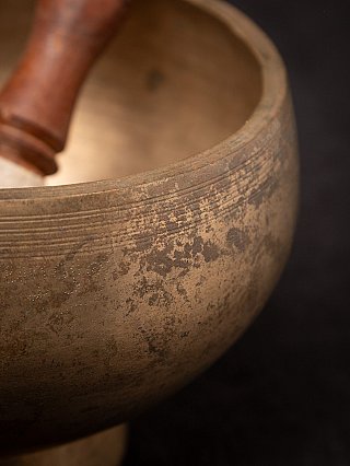 Close-up of rim and patina on the Nepali bronze singing bowl, striker blurred