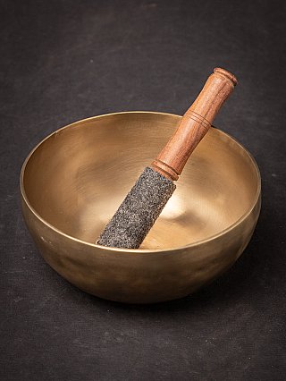 Nepali bronze singing bowl seen from above with striker resting inside