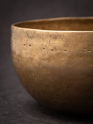 Outer wall detail of the Nepali bronze singing bowl showing fine horizontal lines