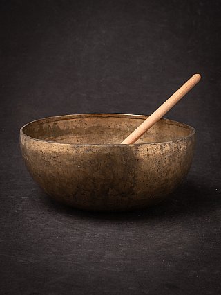 Nepali bronze singing bowl (19th century) with wooden mallet, three-quarter view