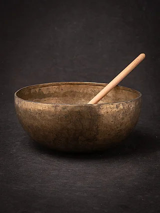 Nepali bronze singing bowl (19th century) with wooden mallet, three-quarter view