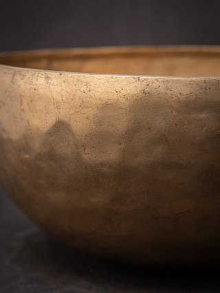 Detail of the outer wall with hammered texture and patina on the Nepali bronze singing bowl