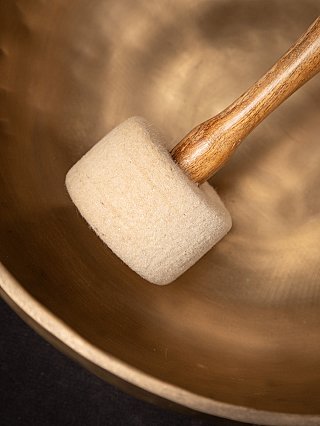 Detail of the striker with white felt head inside the Nepali bronze singing bowl