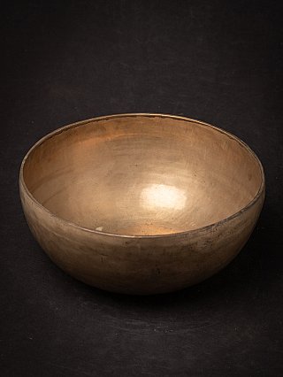 Large Nepali bronze singing bowl, angled view showing reflective interior surface
