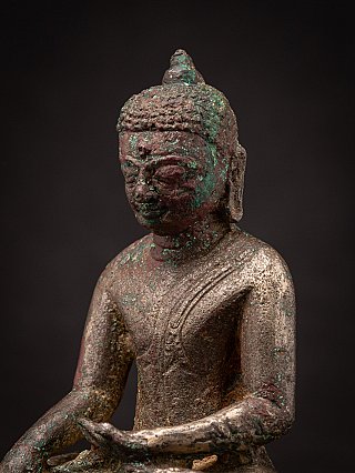 Three-quarter face detail of the bronze Bagan Buddha statue, showing ear and shoulder