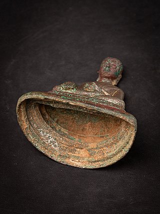 Underside view of the bronze Buddha statue showing hollow base and rim