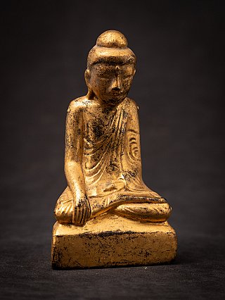 Burmese Shan Buddha statue in wood, angled front view with bhumisparsha hand visible
