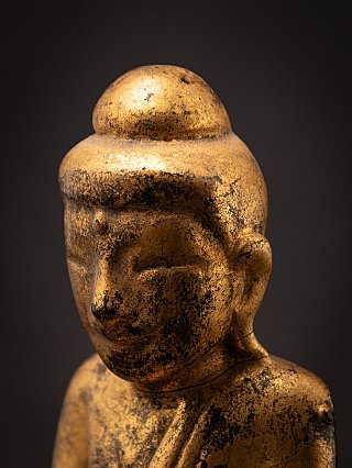 Side face detail of the Burmese Shan wooden Buddha, showing ear and ushnisha