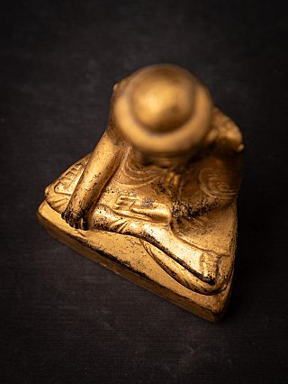 Burmese Shan Buddha statue in wood, top view angled showing both hands on the lap