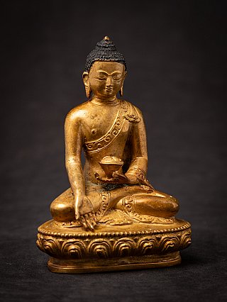 Nepali bronze Buddha statue in full front view with bowl and lotus base clearly visible