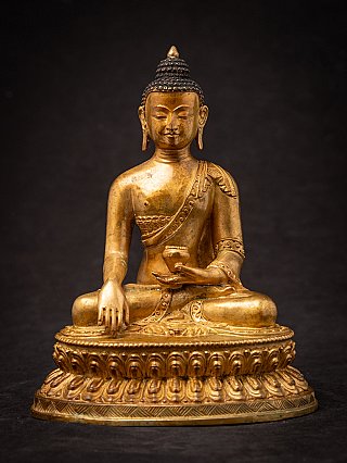Nepali bronze Buddha statue seated on lotus base, full front view with bhumisparsha mudra