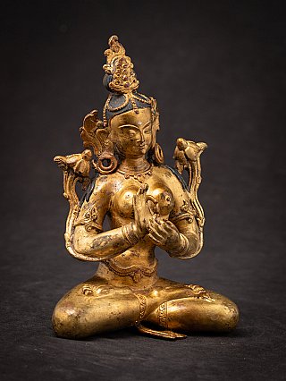 Nepali Green Tara bronze statue seated with dharmachakra mudra, slightly angled view