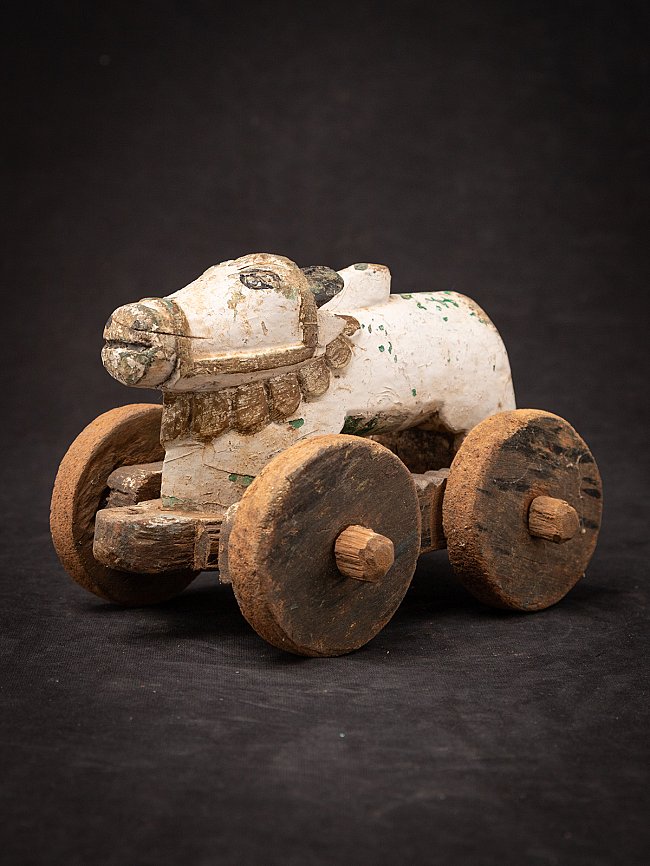 Antique wooden Indian Nandi bull statue on wheels, three-quarter left front view