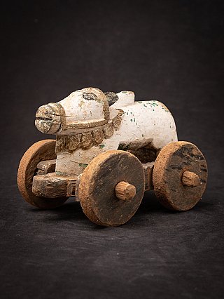 Antique wooden Indian Nandi bull statue on wheels, three-quarter left front view