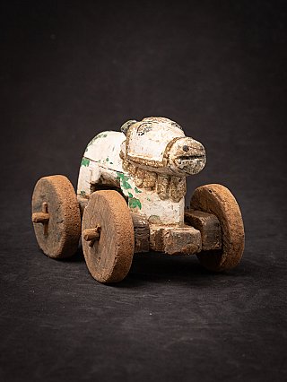 Antique wooden Indian Nandi bull statue on wheels, three-quarter right front view