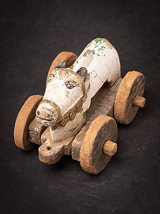 Wooden Indian Nandi bull statue on wheels, angled top view showing all four wheels