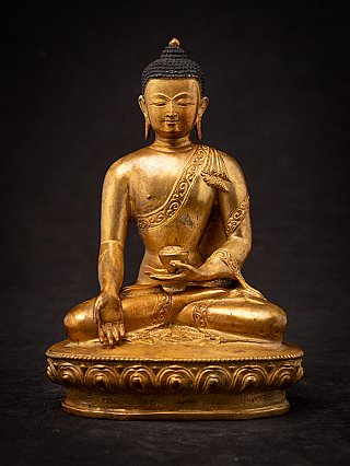 Nepali bronze Buddha statue seated in varada mudra on lotus base, full front view