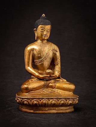 Nepali bronze Buddha statue in dhyana mudra, slightly angled front view on base