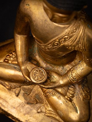 Top angled detail of the Nepali bronze Buddha statue hands holding a bowl over crossed legs