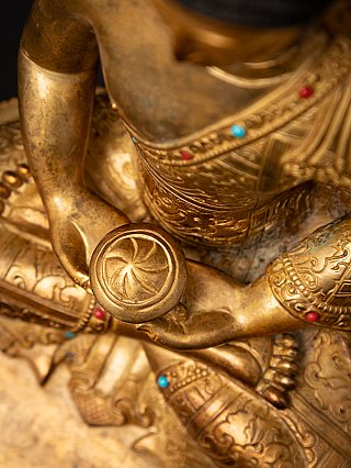 Close-up of the bowl in the hands with the inlaid robe around the waist