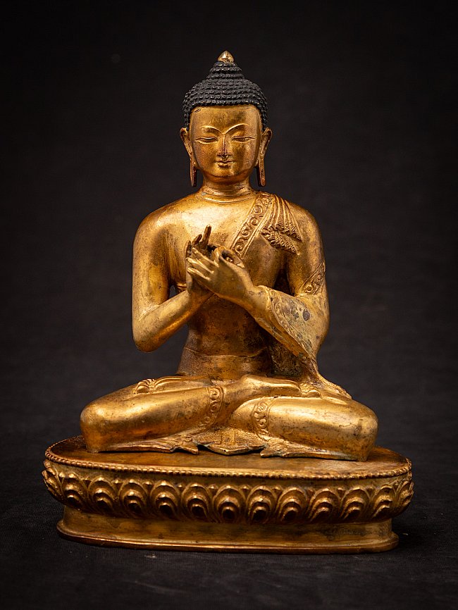 Nepali bronze Buddha statue seated with Dharmachakra mudra, full front view on lotus base