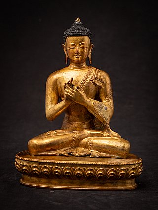 Nepali bronze Buddha statue seated with Dharmachakra mudra, full front view on lotus base