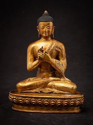 Nepali bronze Buddha statue seated with Dharmachakra mudra, full front view on lotus base