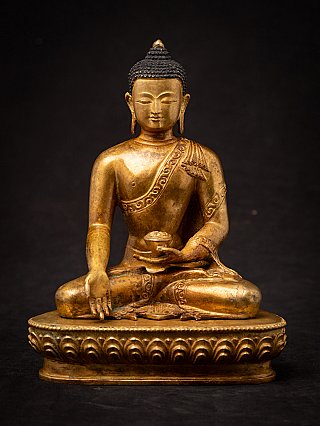 Nepali bronze Buddha statue, full front view seated on lotus base with varada mudra