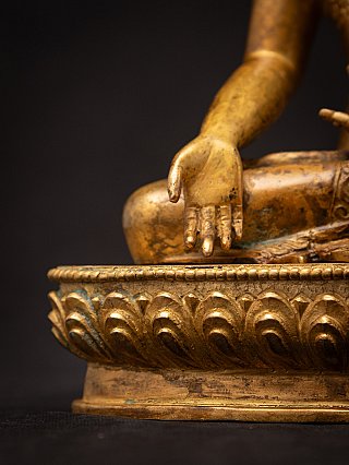 Varada mudra hand detail with the lotus base in the foreground